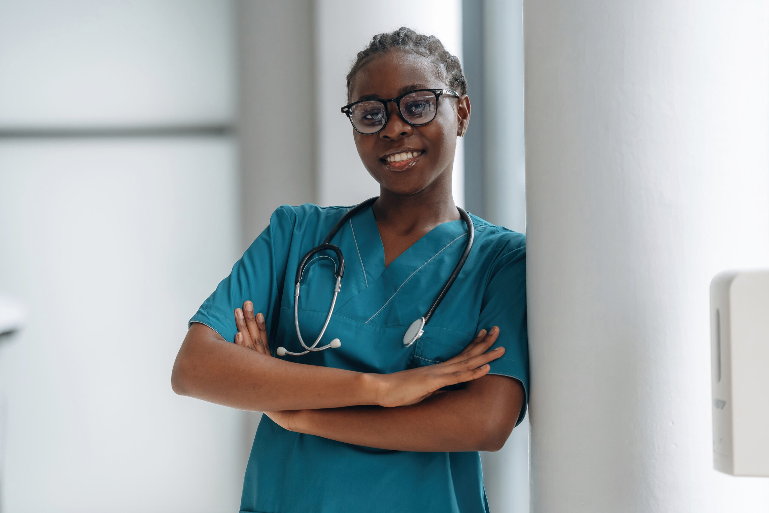 Professional female doctor is standing indoors in modern room